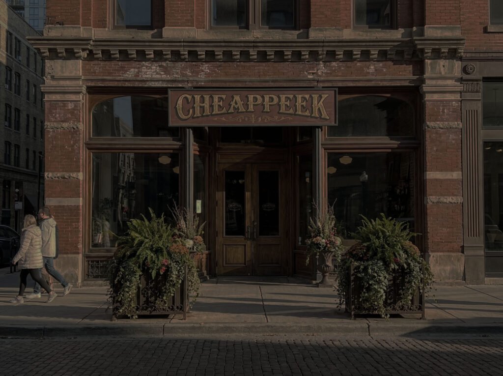 Luxury shopping district street view on a sunny day, featuring high-end fashion stores like Gucci, Louis Vuitton, and Chanel, perfect for finding authentic designer deals at Cheappeak